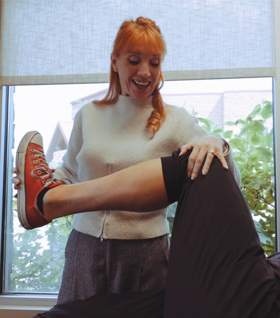 Provider examining a patient's knee during a consultation at Integrated Pain Specialists