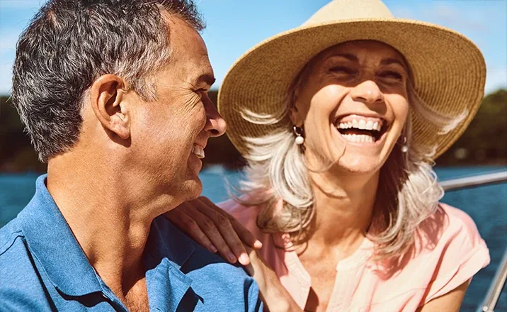 Smiling older couple enjoying a day on the water after knee pain relief